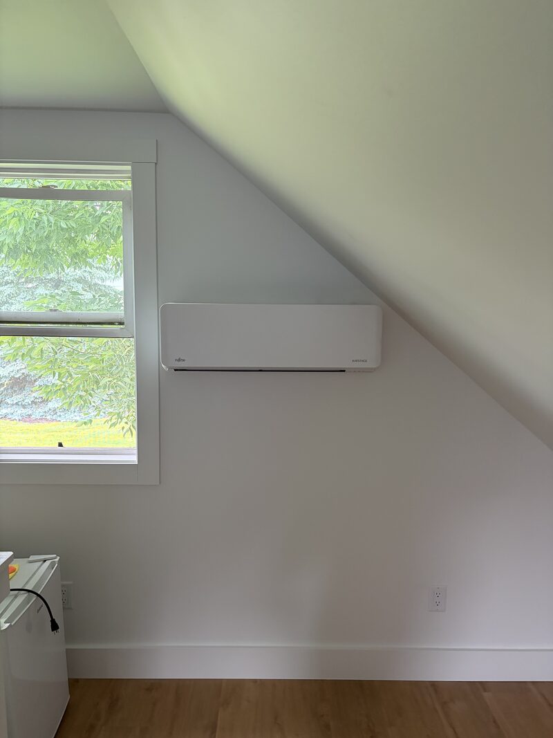 Indoor mini-split unit installed on a bedroom wall for quiet zoned comfort